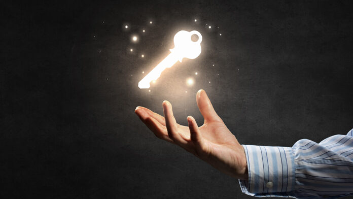 Close,Up,Of,Businessman,Hand,Showing,Key,To,Success